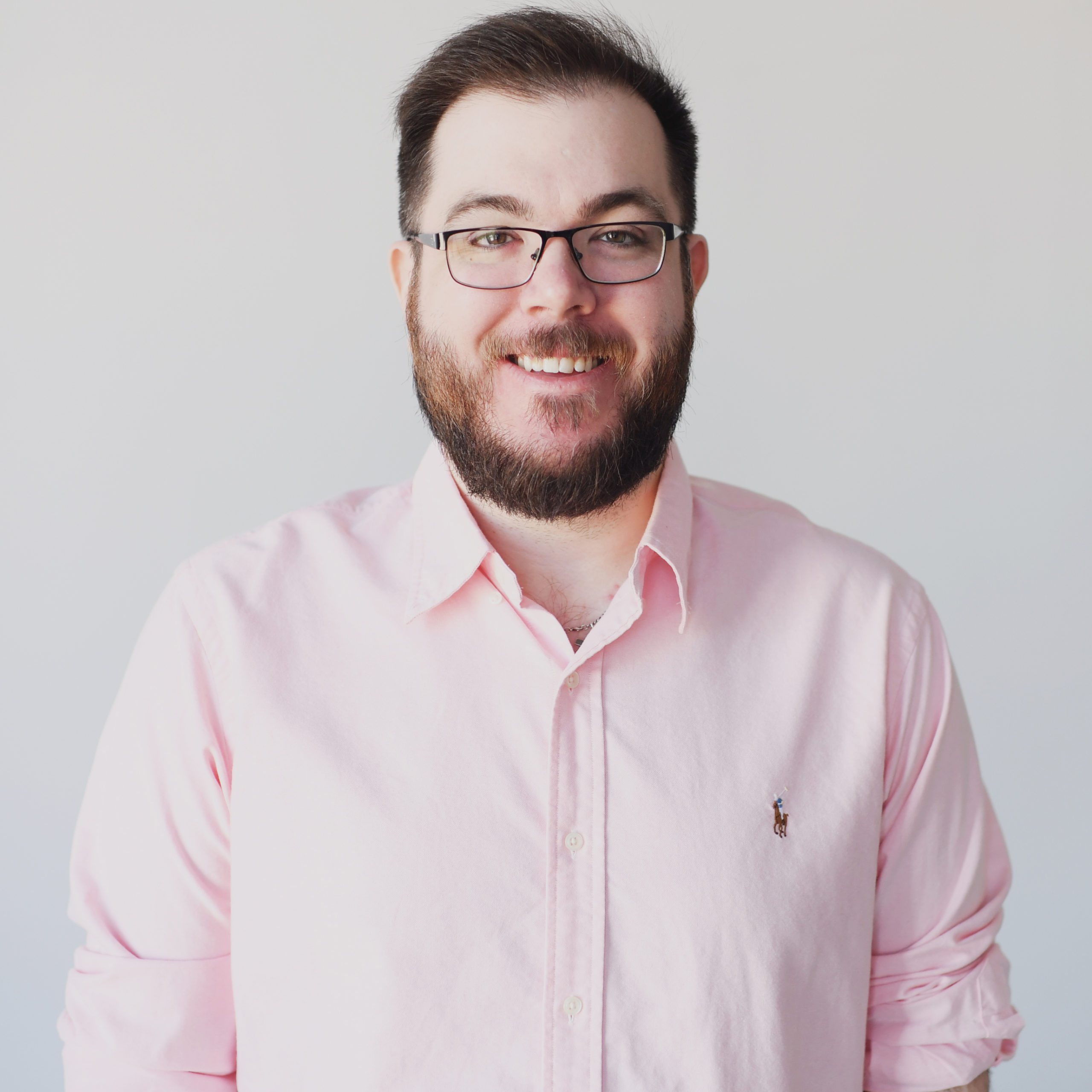 itmeJP wearing glasses and wearing a light pink collared shirt against a white background